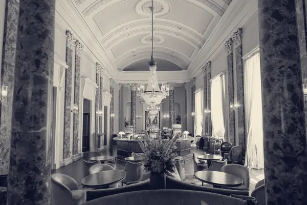 The Grand Saloon at Theatre Royal Drury Lane, with marble columns and a crystal chandelier